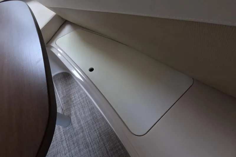 Slide: The Image of Interior storage compartment on 2012 Four Winns V265 boat, featuring a sleek design. - 58