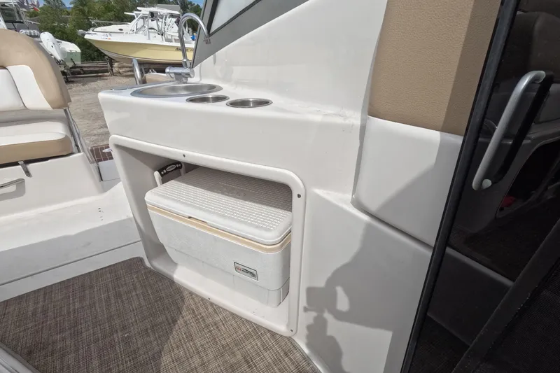 Slide: The Image of 2012 Four Winns V265 boat interior with sink and cooler storage. - 65