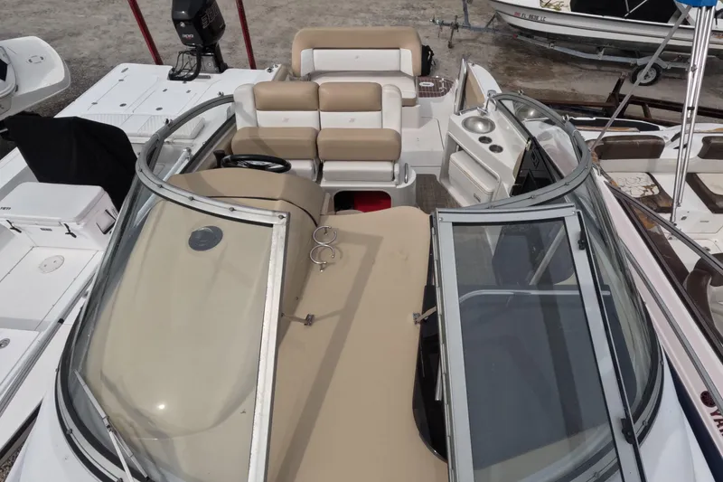Slide: The Image of 2012 Four Winns V265 boat interior with beige seating and steering wheel. - 69