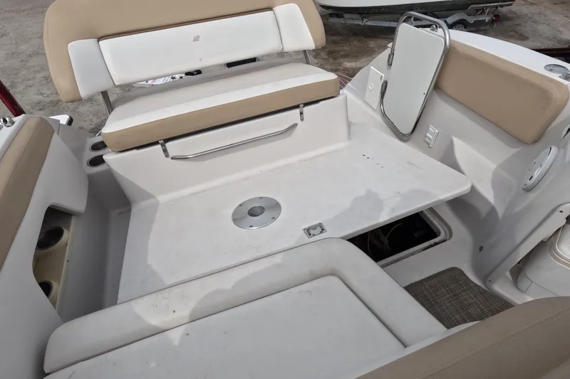 Slide: The Image of 2012 Four Winns V265 boat interior with beige seating and storage compartments. - 70