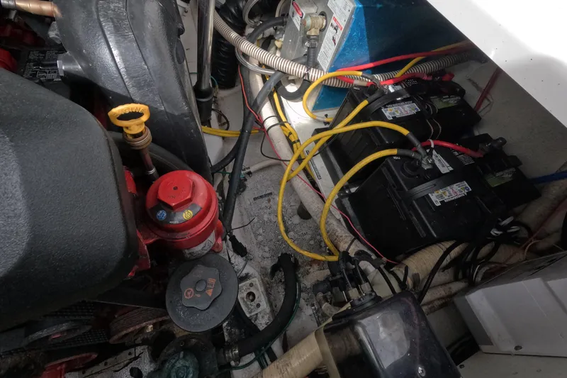 Slide: The Image of Engine compartment of a 2012 Four Winns V265 boat, showing batteries and wiring. - 73