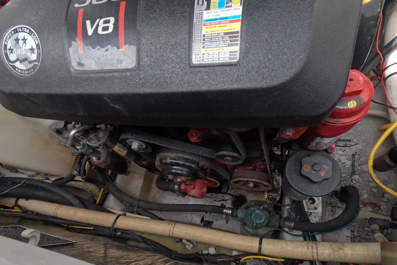 Slide: The Image of Engine compartment of a 2012 Four Winns V265 boat with V8 engine components. - 74