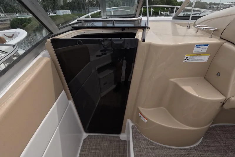 Slide: The Image of Interior view of 2012 Four Winns V265 boat cabin entrance with beige seating. - 79
