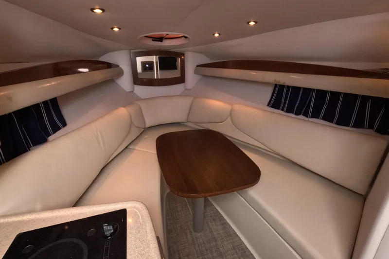 Slide: The Image of Luxurious interior of 2012 Four Winns V265 boat with cozy seating and wooden table. - 8