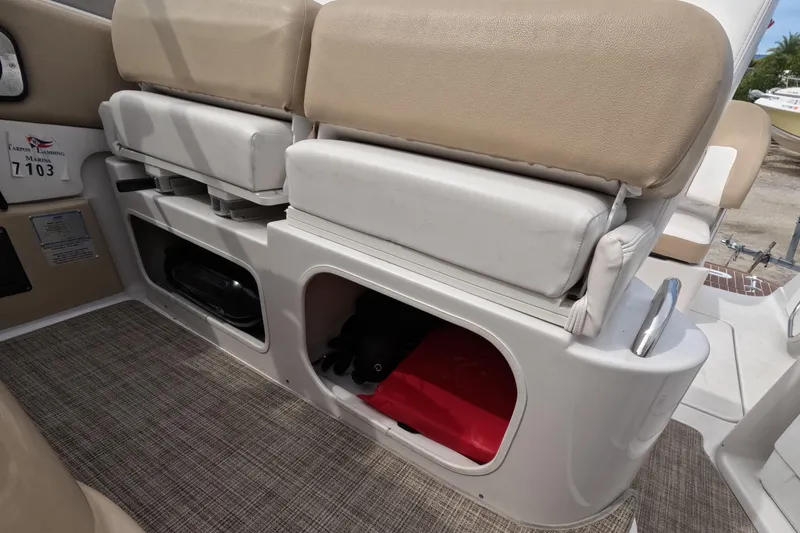 Slide: The Image of 2012 Four Winns V265 boat interior with beige seating and storage compartments. - 81