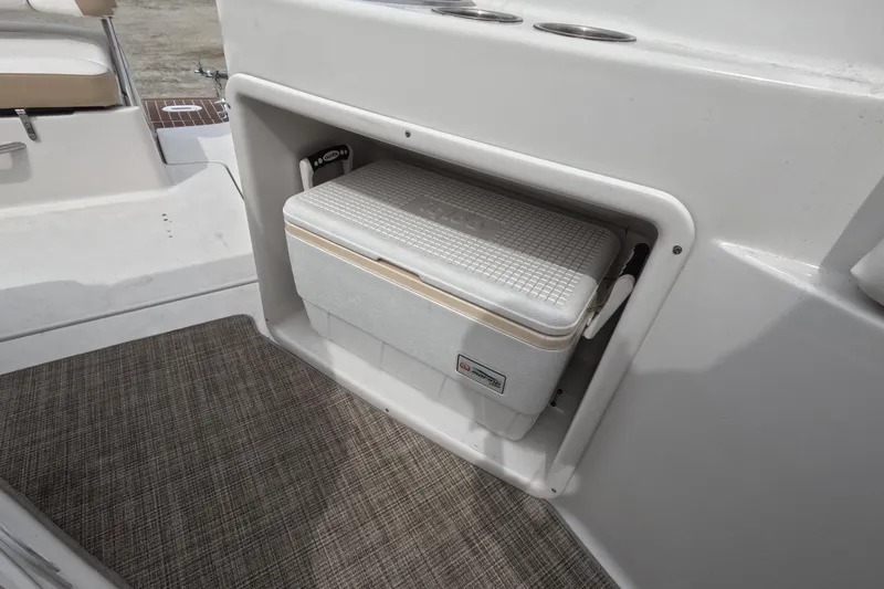 Slide: The Image of 2012 Four Winns V265 boat with built-in cooler storage compartment. - 82