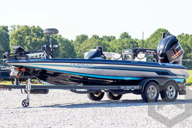 The Image of 2018 Skeeter ZX250 boat on trailer, parked outdoors on gravel. - 1