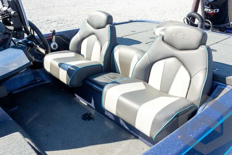 Slide: The Image of 2018 Skeeter ZX250 boat interior with dual gray seats and steering console. - 11