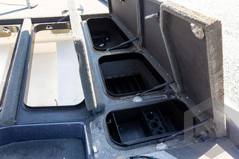 Slide: The Image of 2018 Skeeter ZX250 boat storage compartments with open lids, showcasing interior space. - 24
