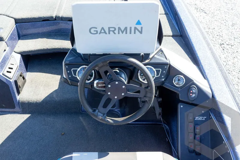 Slide: The Image of 2018 Skeeter ZX250 boat dashboard with Garmin navigation system and steering wheel. - 29
