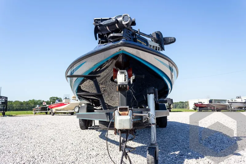 Slide: The Image of 2018 Skeeter ZX250 boat on trailer, parked on gravel lot under clear blue sky. - 3