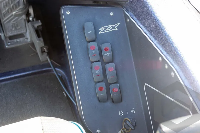 Slide: The Image of Control panel of a 2018 Skeeter ZX250 boat with labeled switches. - 30