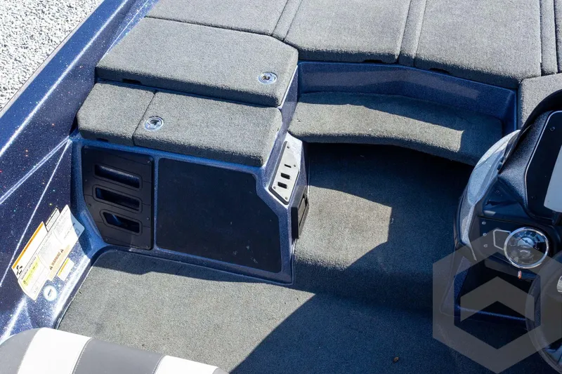 Slide: The Image of 2018 Skeeter ZX250 boat interior with carpeted flooring and storage compartments. - 31