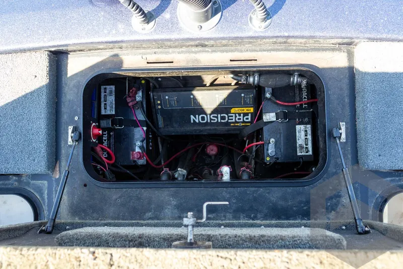 Slide: The Image of Battery compartment of a 2018 Skeeter ZX250 boat, showing multiple batteries and wiring. - 34