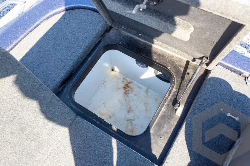 Slide: The Image of Open storage compartment on 2018 Skeeter ZX250 boat, showing interior details. - 35