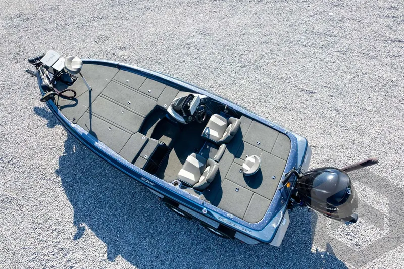 Slide: The Image of 2018 Skeeter ZX250 fishing boat with dual seats and motor, viewed from above on gravel. - 42
