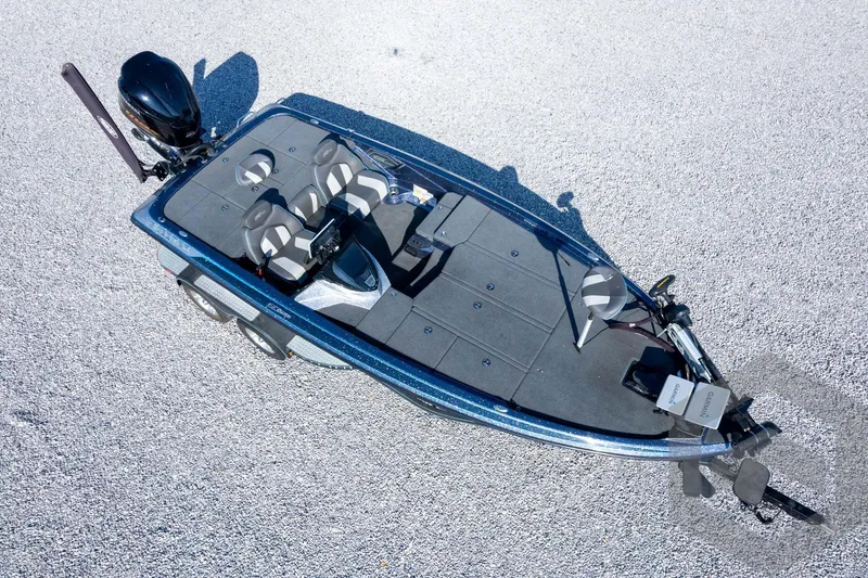 Slide: The Image of 2018 Skeeter ZX250 bass boat on gravel, featuring dual seats and advanced navigation equipment. - 46