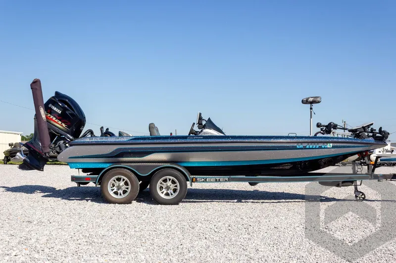 Slide: The Image of 2018 Skeeter ZX250 bass boat on trailer, side view, clear sky background. - 5