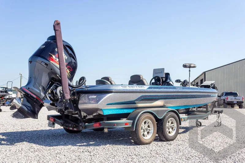 Slide: The Image of 2018 Skeeter ZX250 boat with Yamaha engine on a trailer, parked on gravel. - 6