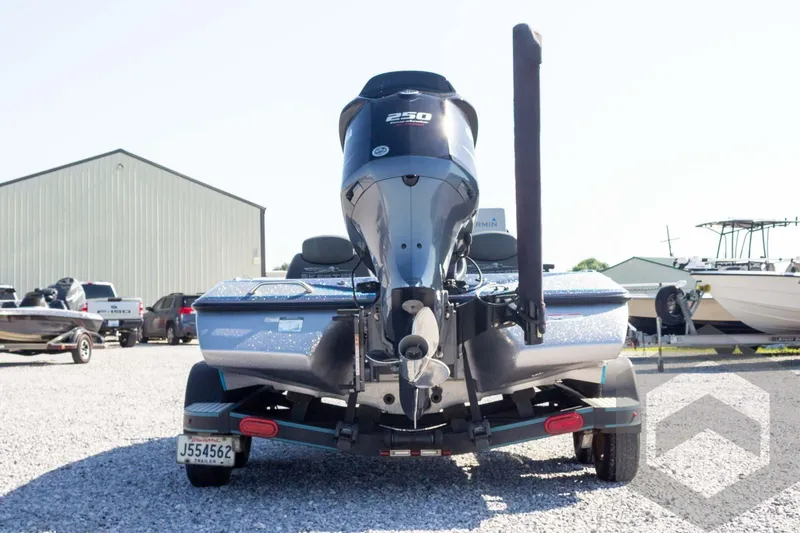 Slide: The Image of 2018 Skeeter ZX250 boat with powerful engine, parked on gravel lot. - 7