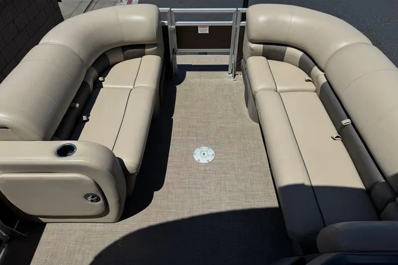 Slide: The Image of 2024 Sun Tracker SportFish 22 DLX interior with beige seating and spacious layout. - 11
