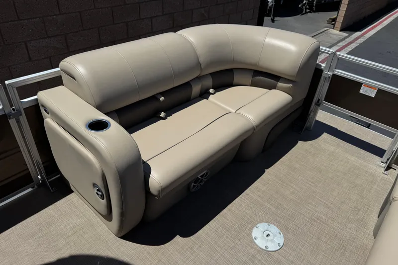 Slide: The Image of 2024 Sun Tracker SportFish 22 DLX pontoon boat with beige seating and cup holder. - 12