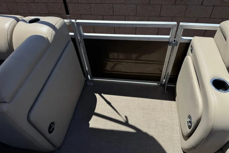 Slide: The Image of 2024 Sun Tracker SportFish 22 DLX interior with beige seating and cup holders. - 15