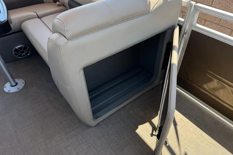 Slide: The Image of 2024 Sun Tracker SportFish 22 DLX boat interior with open storage compartment. - 16