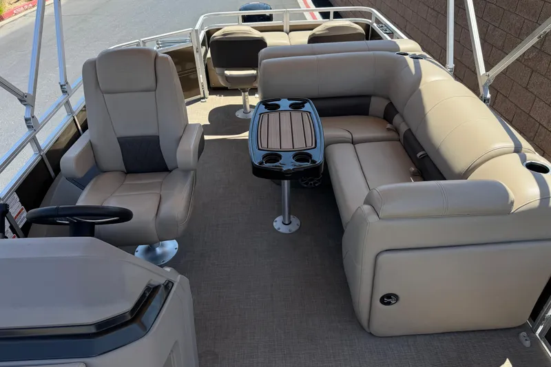 Slide: The Image of 2024 Sun Tracker SportFish 22 DLX interior with beige seating and a central table. - 17