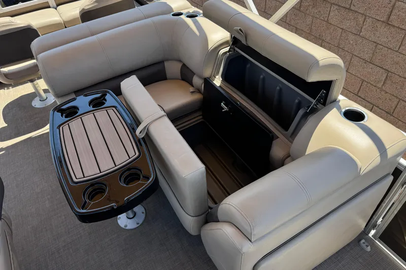 Slide: The Image of 2024 Sun Tracker SportFish 22 DLX boat interior with seating and storage compartment. - 18