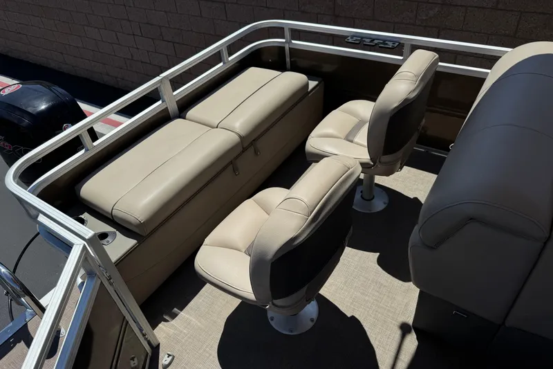 Slide: The Image of 2024 Sun Tracker SportFish 22 DLX boat interior with beige seating and railing. - 19