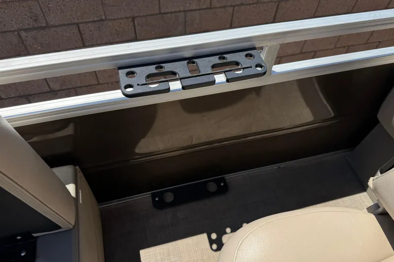 Slide: The Image of 2024 Sun Tracker SportFish 22 DLX interior detail with beige seating and metal railing. - 20