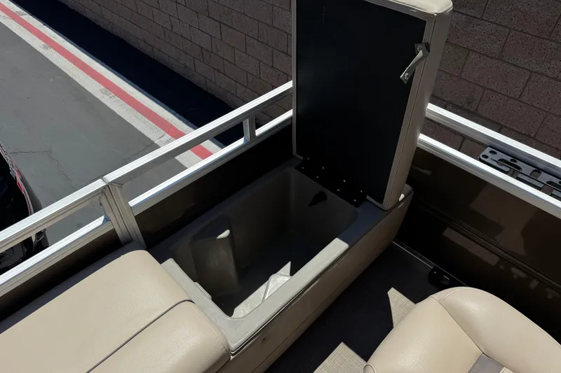 Slide: The Image of 2024 Sun Tracker SportFish 22 DLX boat interior storage compartment open. - 21