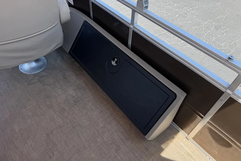 Slide: The Image of 2024 Sun Tracker SportFish 22 DLX interior with storage compartment and seating. - 25