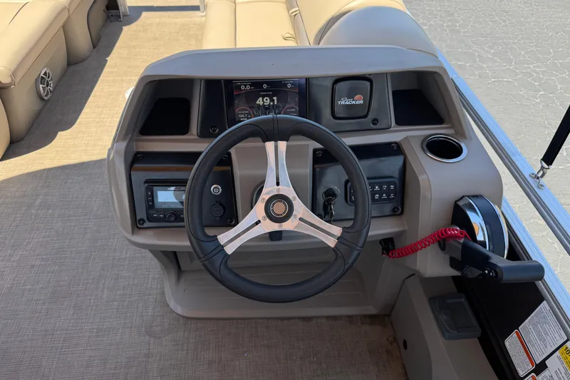Slide: The Image of 2024 Sun Tracker SportFish 22 DLX boat dashboard with steering wheel and controls. - 28