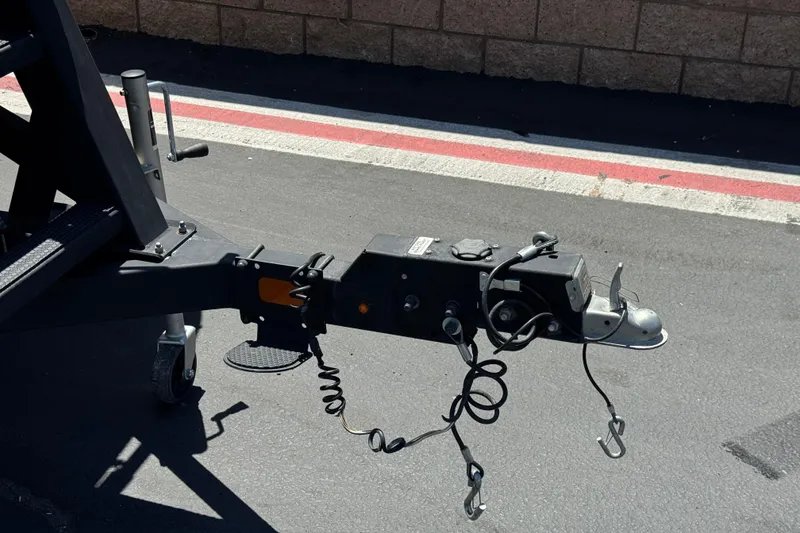 Slide: The Image of Trailer hitch of 2024 Sun Tracker SportFish 22 DLX on asphalt surface. - 33