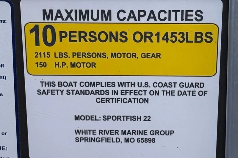 Slide: The Image of 2024 Sun Tracker SportFish 22 DLX capacity label: 10 persons, 1453 lbs, 150 HP motor. - 34
