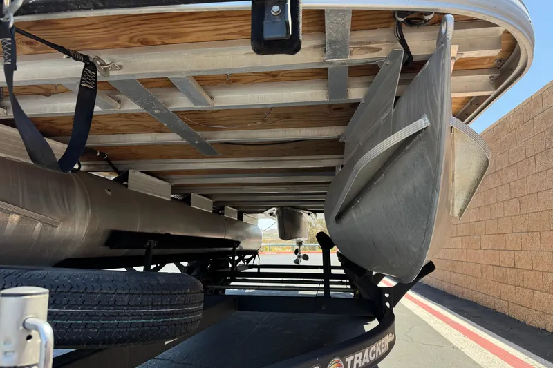 Slide: The Image of Underneath view of a 2024 Sun Tracker SportFish 22 DLX pontoon boat on a trailer. - 4