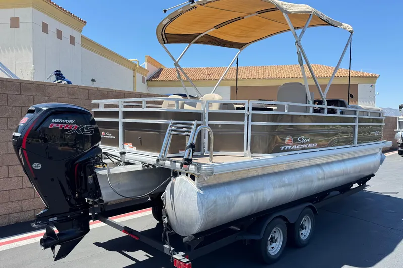 Slide: The Image of 2024 Sun Tracker SportFish 22 DLX pontoon boat with Mercury Pro XS engine on trailer. - 6
