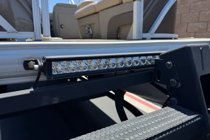 Slide: The Image of 2024 Sun Tracker SportFish 22 DLX pontoon boat with LED light bar detail. - 9