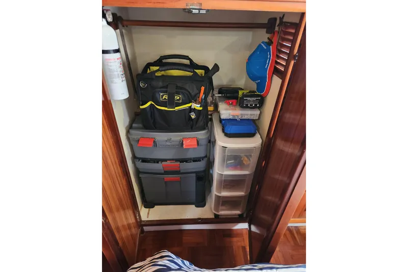Slide: The Image of Storage closet on a 1987 Jefferson 42 SE Sundeck Motor Yacht with organized tools and equipment. - 23