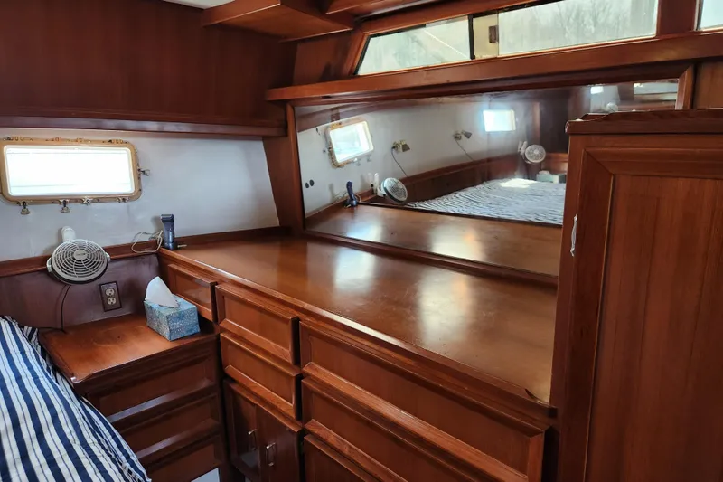 Slide: The Image of Interior of 1987 Jefferson 42 SE Sundeck Motor Yacht with wooden cabinetry and mirror. - 29