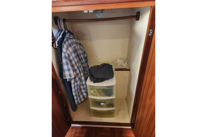 Slide: The Image of Closet interior on 1987 Jefferson 42 SE Sundeck Motor Yacht with clothes and storage drawers. - 37