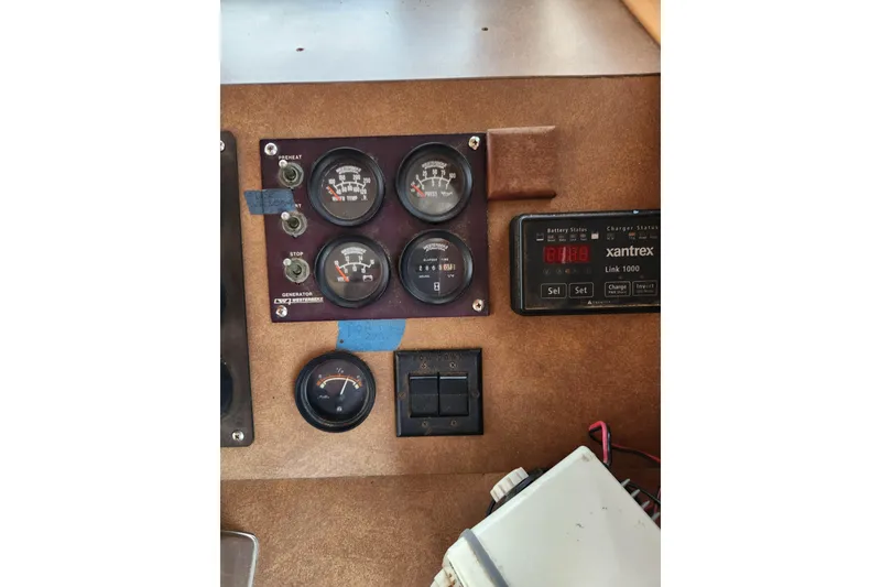 Slide: The Image of Control panel of a 1987 Jefferson 42 SE Sundeck Motor Yacht with gauges and Xantrex charger. - 43