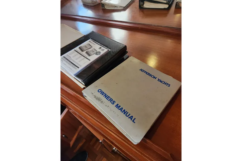 Slide: The Image of Owner's manual for 1987 Jefferson 42 SE Sundeck Motor Yacht on wooden table. - 44