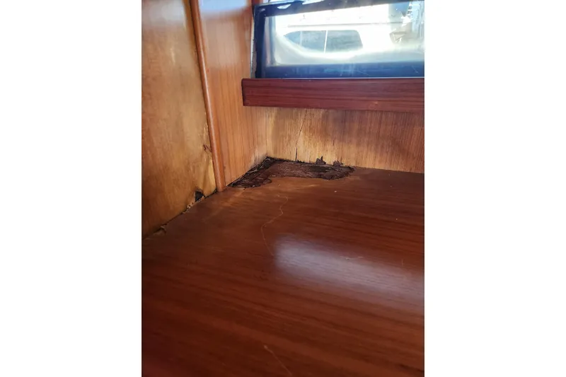 Slide: The Image of Interior wood damage on 1987 Jefferson 42 SE Sundeck Motor Yacht near window. - 45