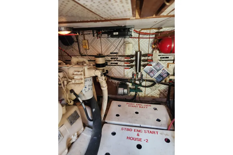 Slide: The Image of Engine room of 1987 Jefferson 42 SE Sundeck Motor Yacht with visible machinery and wiring. - 47
