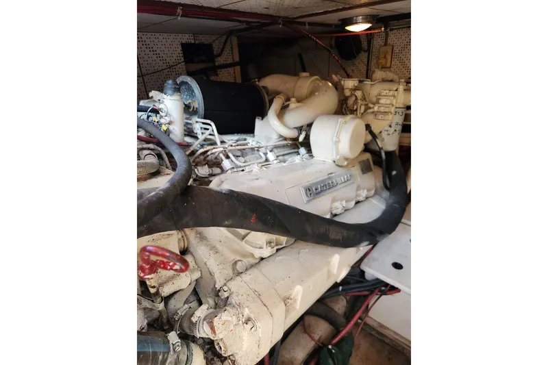 Slide: The Image of Engine room of 1987 Jefferson 42 SE Sundeck Motor Yacht, featuring a Caterpillar engine. - 49