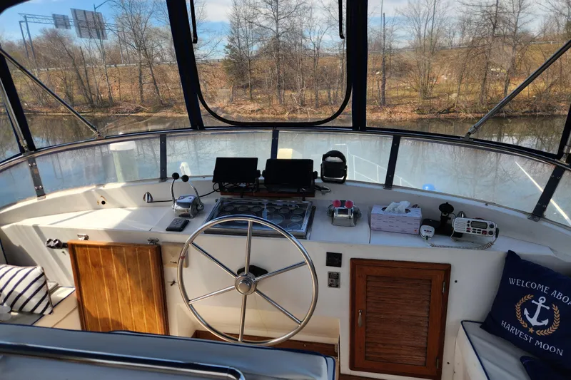 Slide: The Image of Cockpit of 1987 Jefferson 42 SE Sundeck Motor Yacht with steering wheel and navigation equipment. - 8