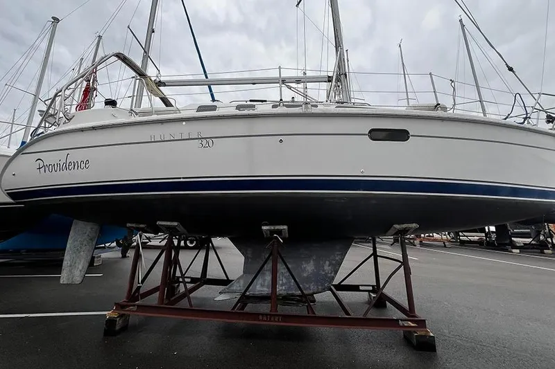 Slide: The Image of 2001 Marlow-Hunter 320 sailboat named Providence on stands in a marina. - 14